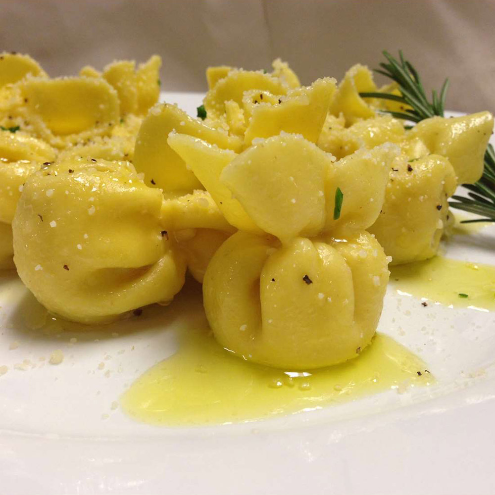 Joseph's Gourmet pasta truffle sacchetti on a plate with seasonings and olive oil