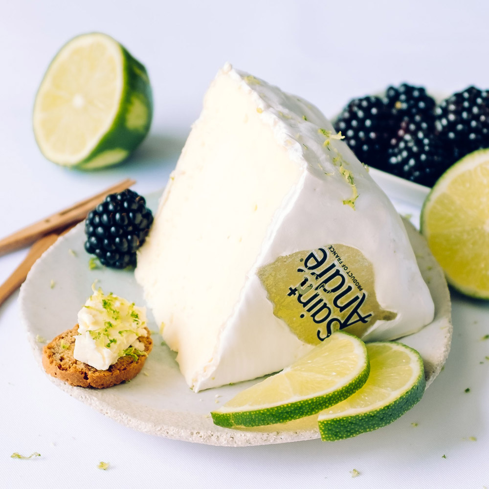 Saint André cheese on a plate with cookies and limes and berries