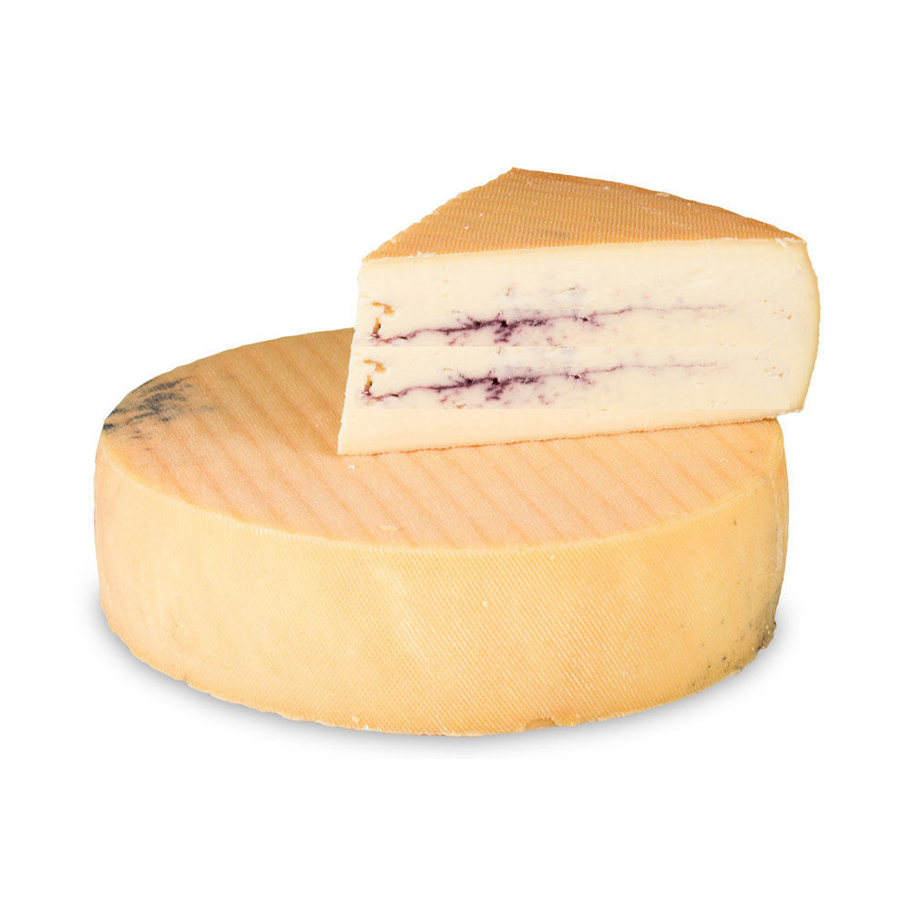 A wheel of Montboissie du haut Livradois cheese with a wedge of cheese on top