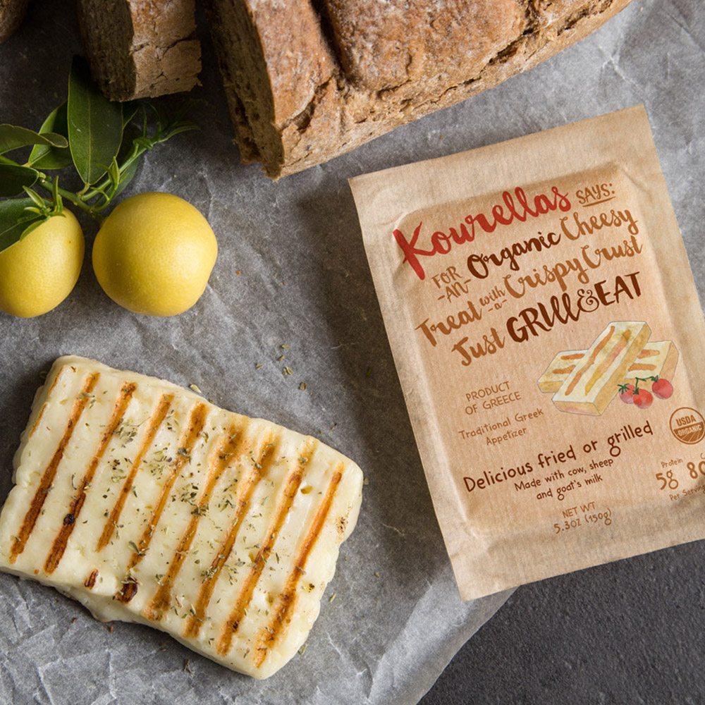 A package of Kourellas Organic Grill & Eat Cheese next to a piece of Kourellas Organic Grill & Eat Cheese and a couple lemons