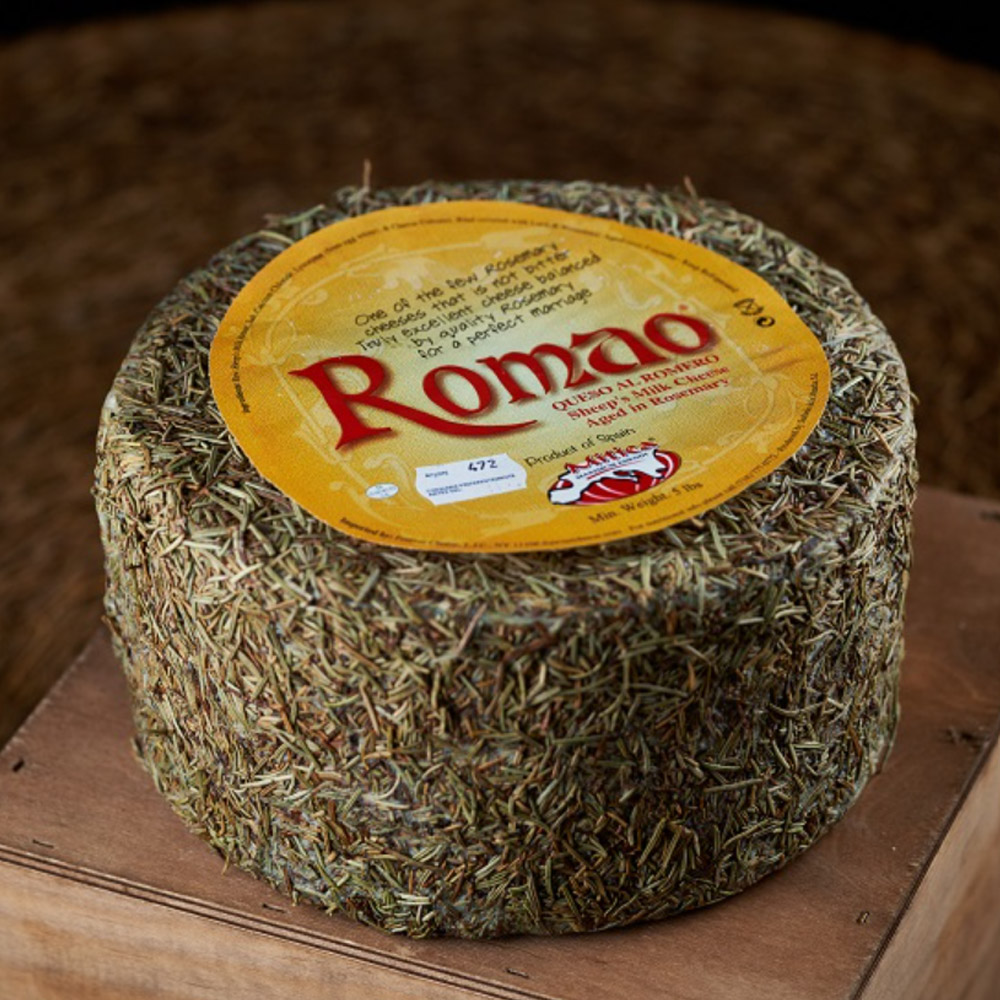 Mitica Romao rosemary cheese wheel on top of a wooden box