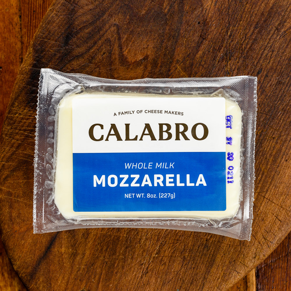 A package of Calabro whole milk mozzarella on a wooden surface