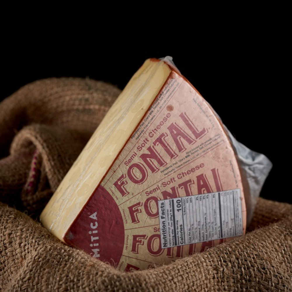 Quarter wheel of Mitica fontal cheese on top of burlap