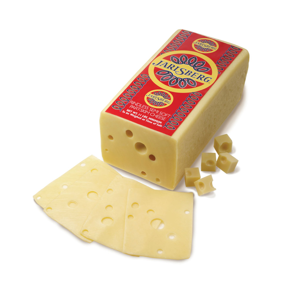 Jarlsberg Swiss cheese loaf with slices and cubes