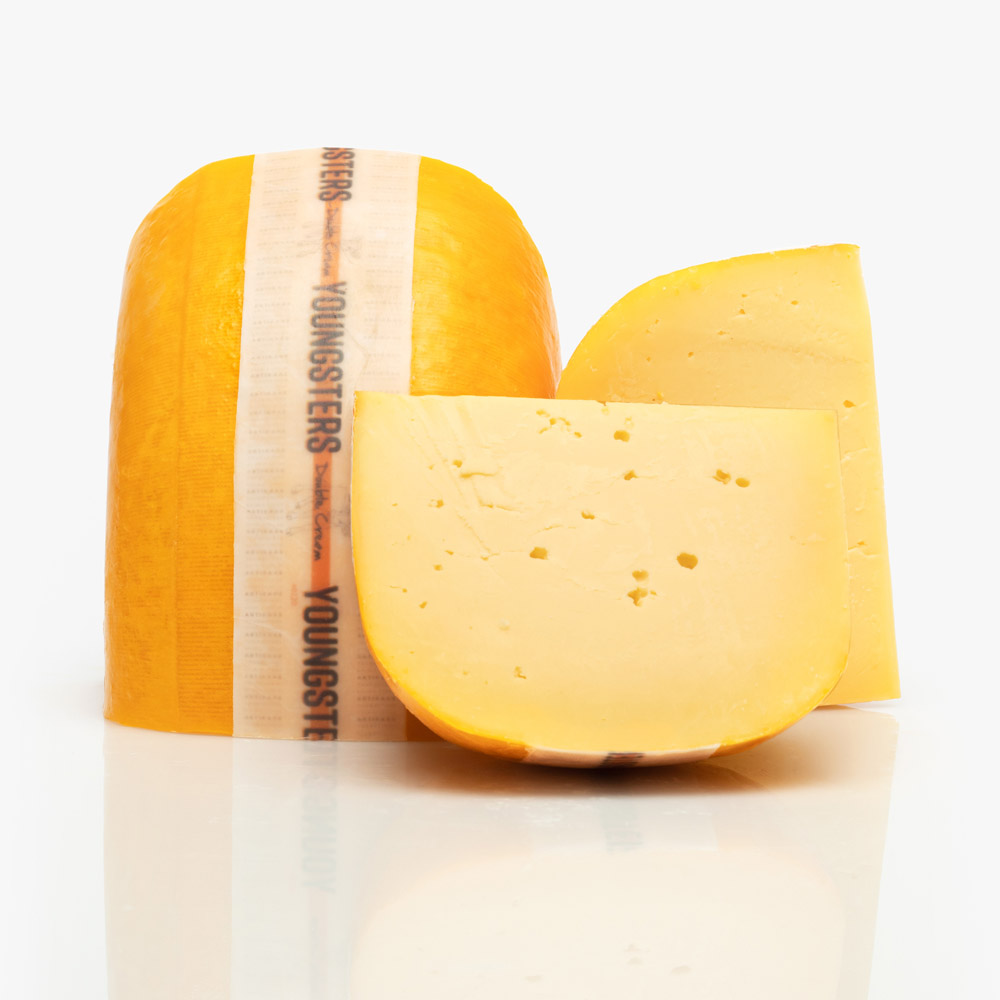 A cut wheel of Artikaas Youngsters Double Cream Gouda