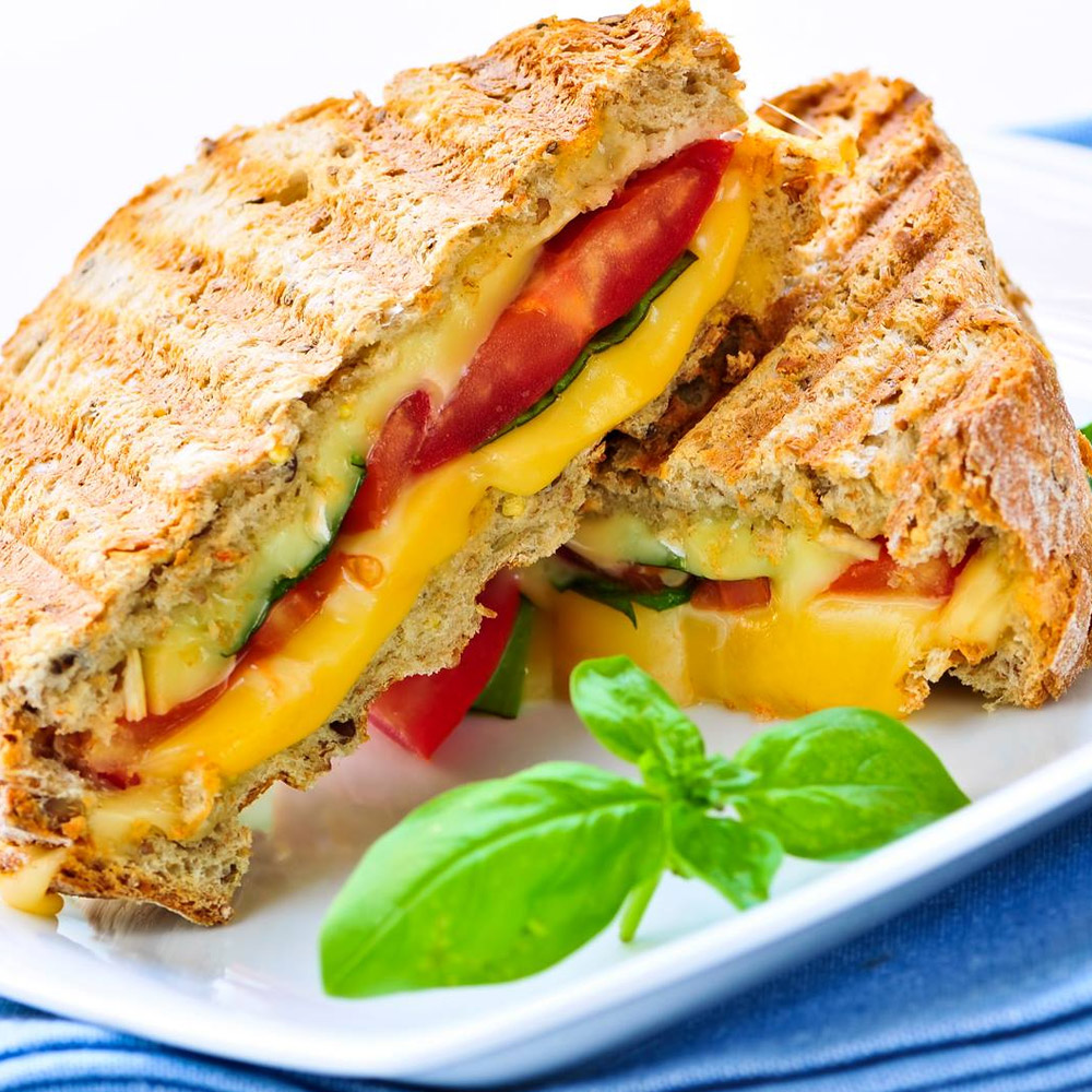A cut tomato grilled cheese sandwich