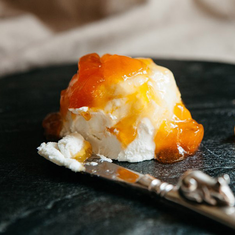 Mackenzie Creamery Apricot Ginger Chèvre on a board next to a cheese knife