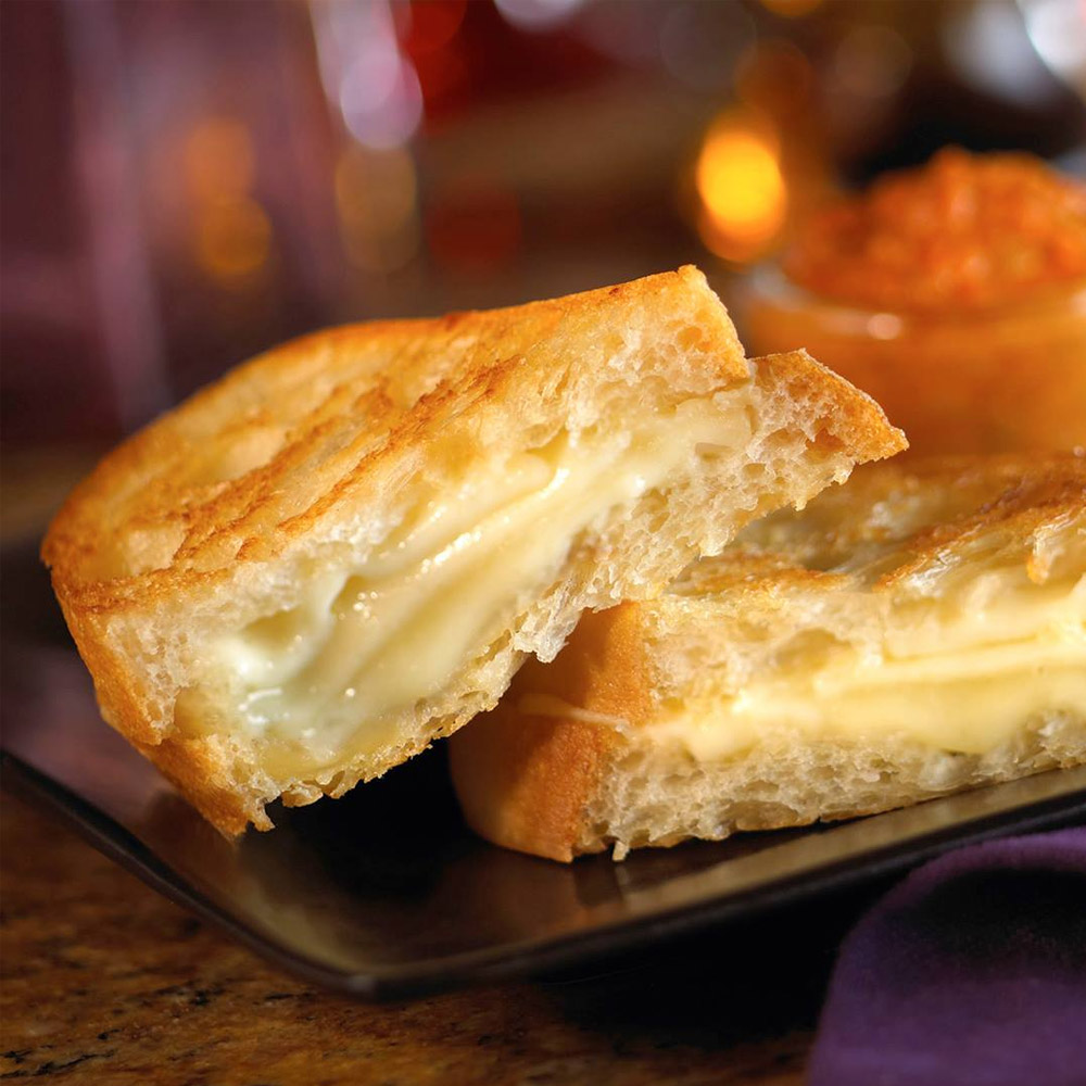 A close-up of a grilled cheese on a plate