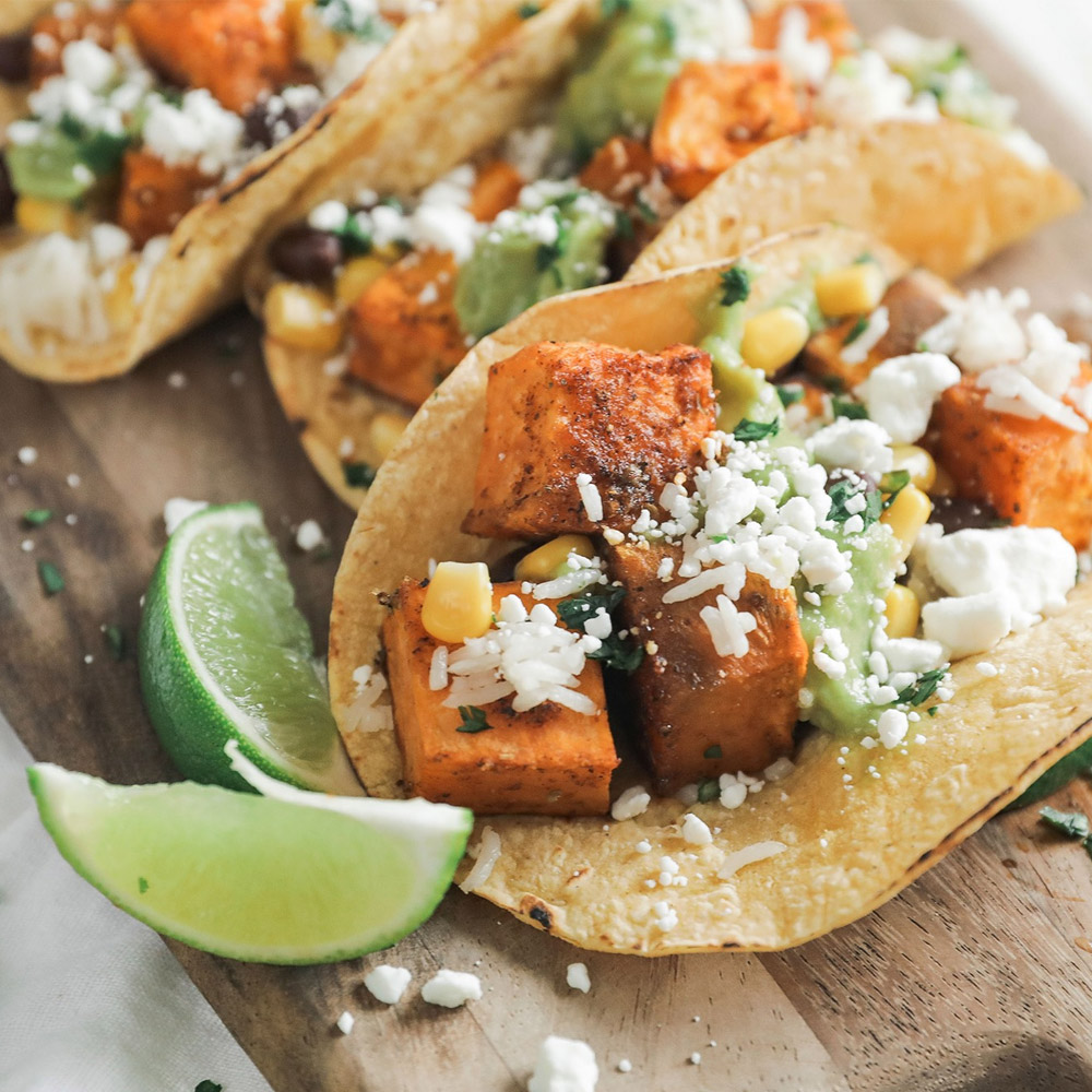 Tacos topped with crumbled goat cheese