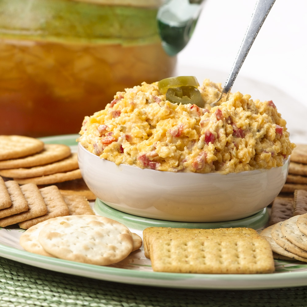 Bowl of pimento cheese on a plate with crackers