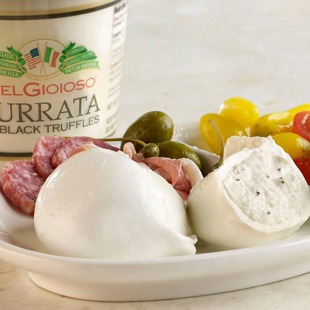 A plate of truffle burrata cut open to reveal the center