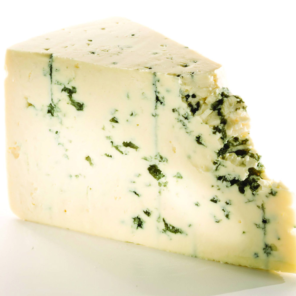 A wedge of blue cheese on a white background