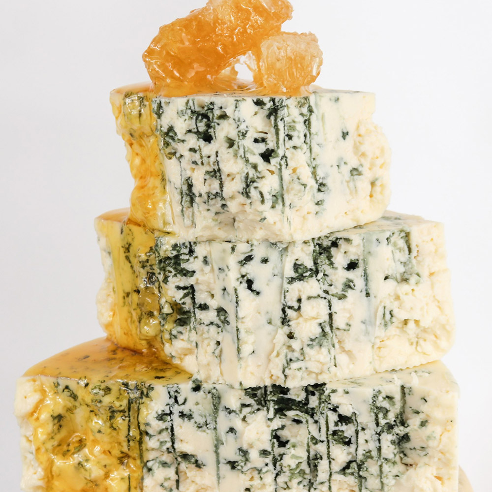 A tower of blue cheese topped with honey and honeycomb