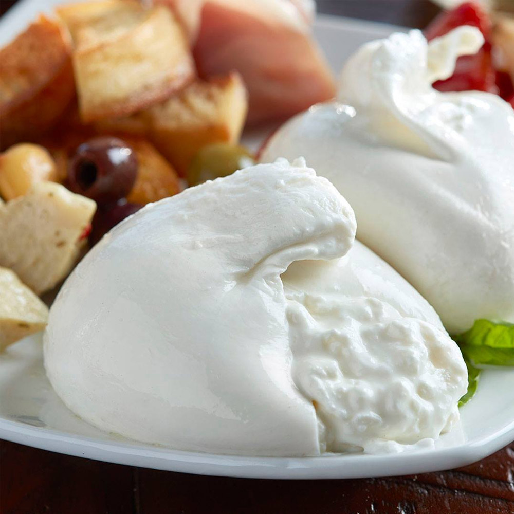 An up-close ball of burrata cut open to reveal the inside