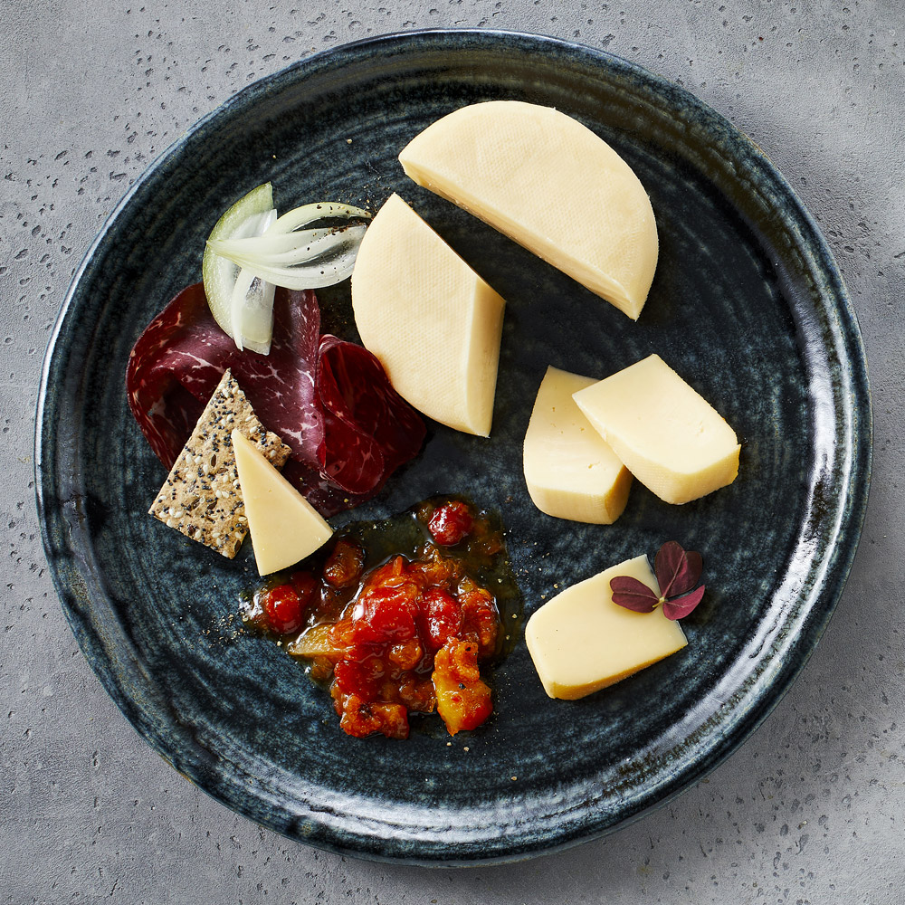 A plate with smoked gouda with accompaniments