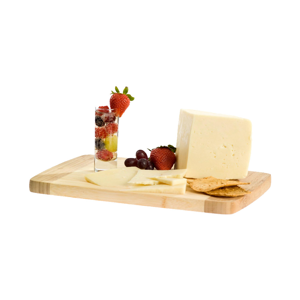 A wedge of Marisa cheese on a wood board with fruit and crackers