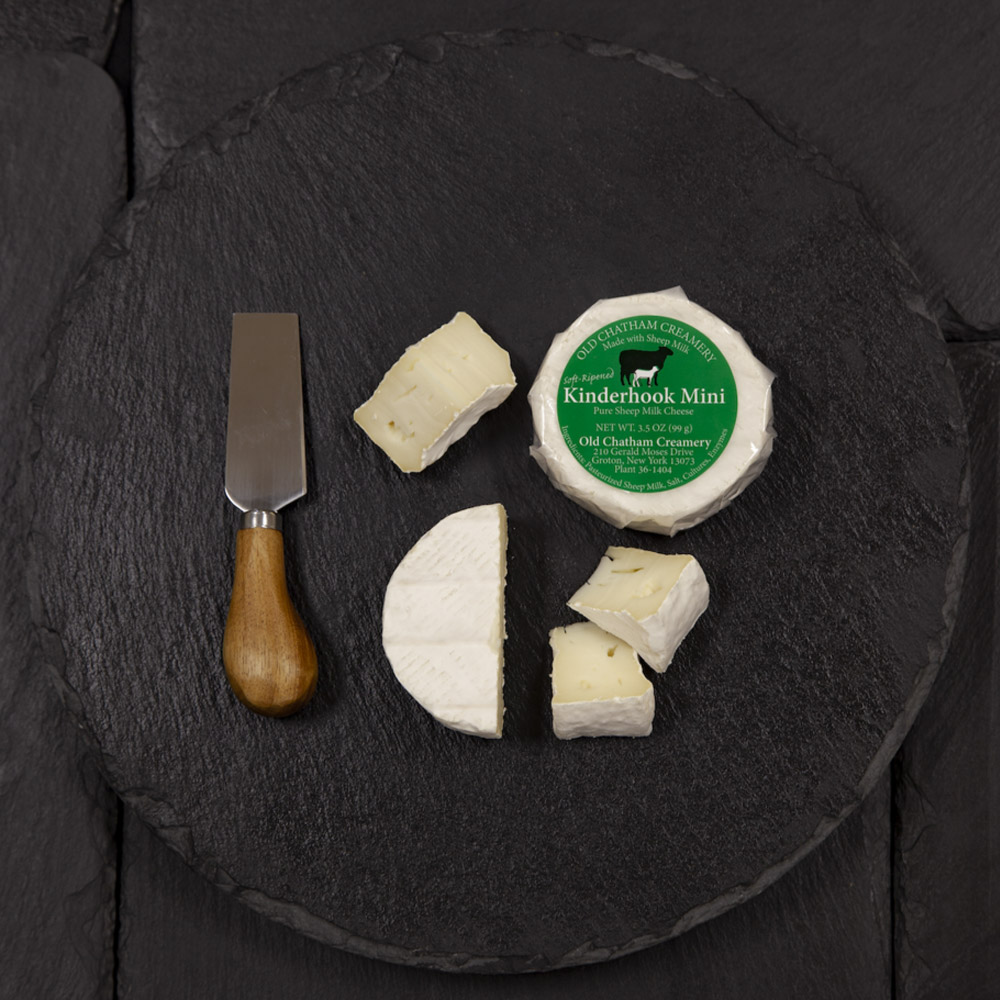 Old Chatham Creamery Mini Kinderhook Creek on a cheese board with a cheese knife