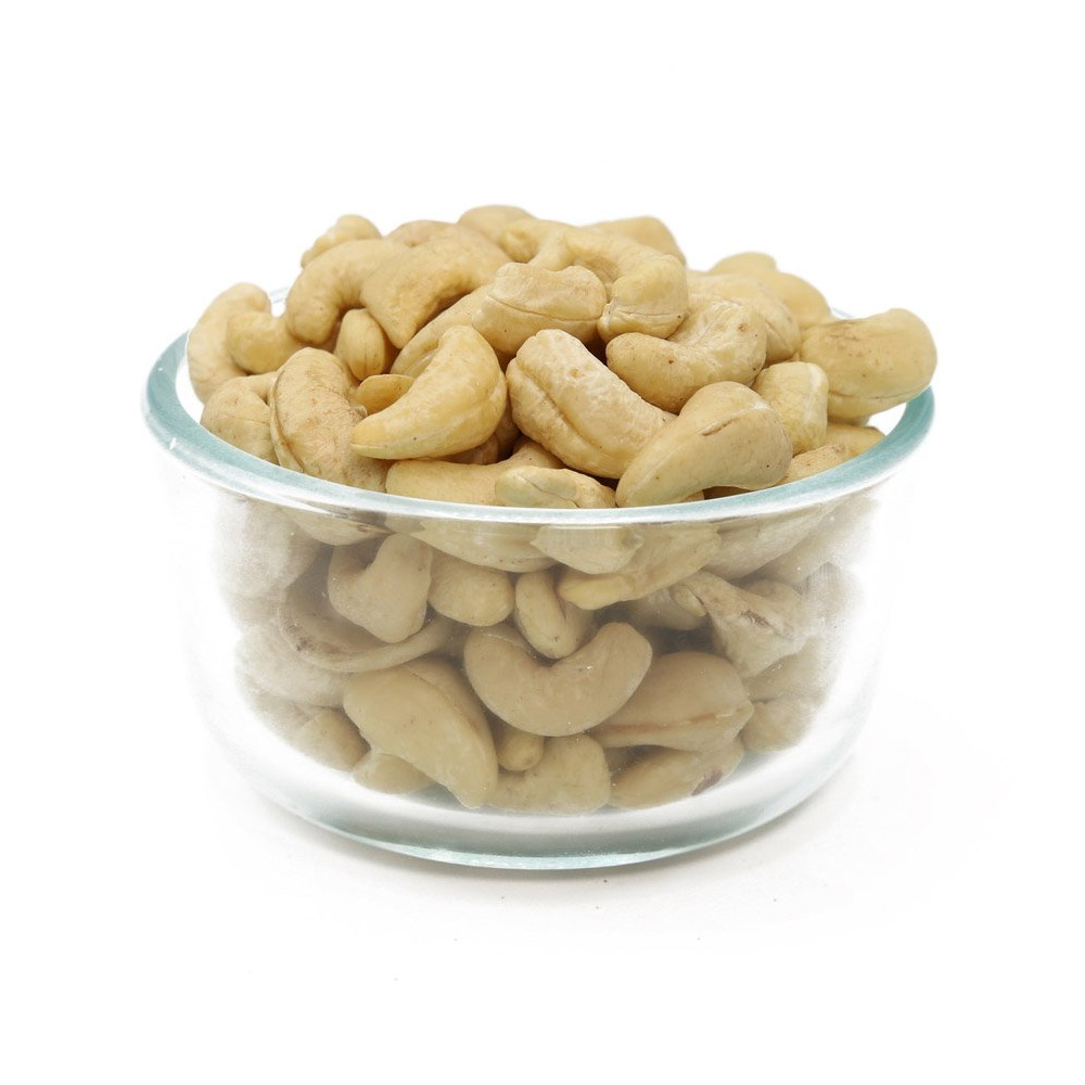 A clear bowl filled with raw cashews