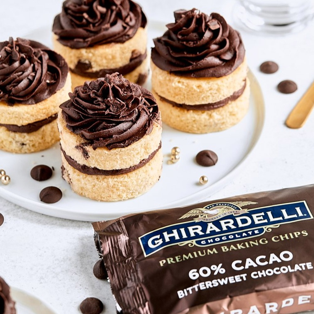 A bag of Ghirardelli chocolate chips in front of a plate of cupcakes