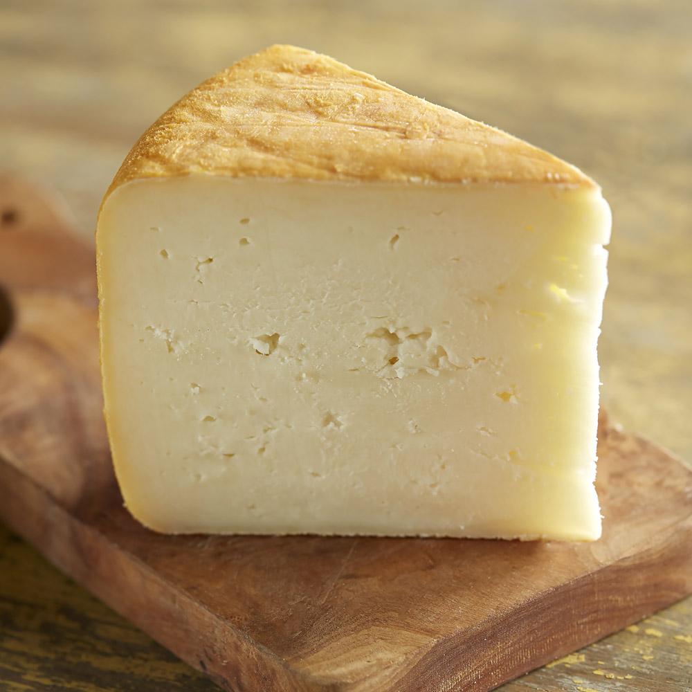 A wedge of Cabra La Mancha cheese on a board