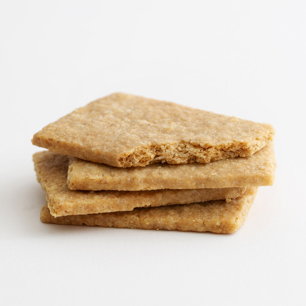 A close-up of a stack of four oatcake biscuits