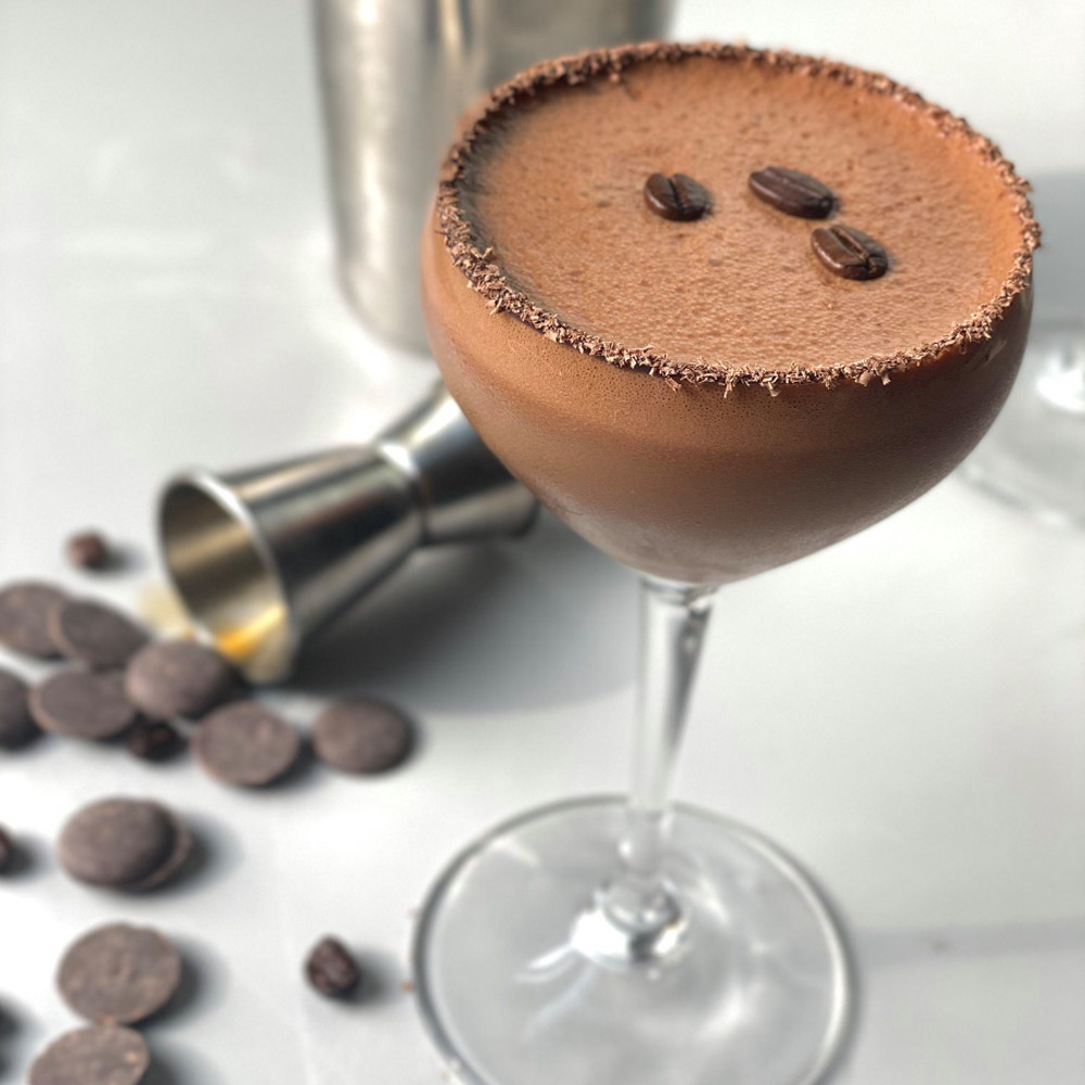 Three Cacao Barry Chocolate Coffee Beans on top of an espresso martini