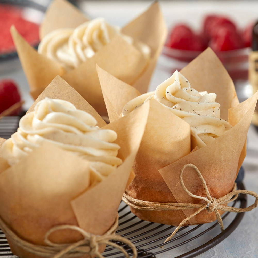 Three cupcakes wrapped in parchment paper
