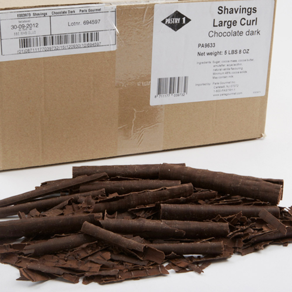Pile of dark chocolate curls in front of a box