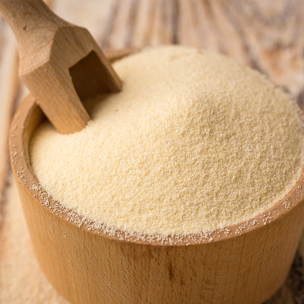 Semolina in bowl on a wooden background