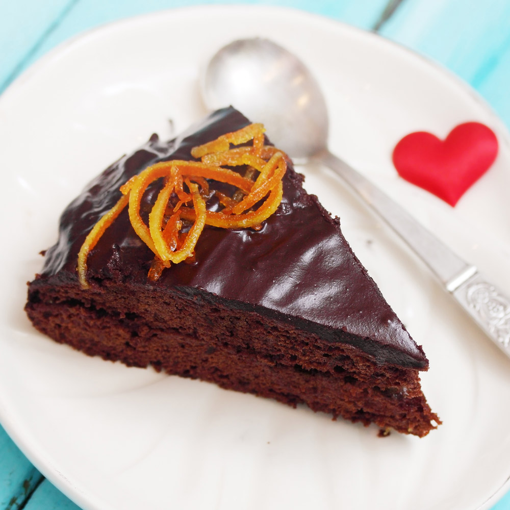A piece of chocolate cake topped with candied orange peel