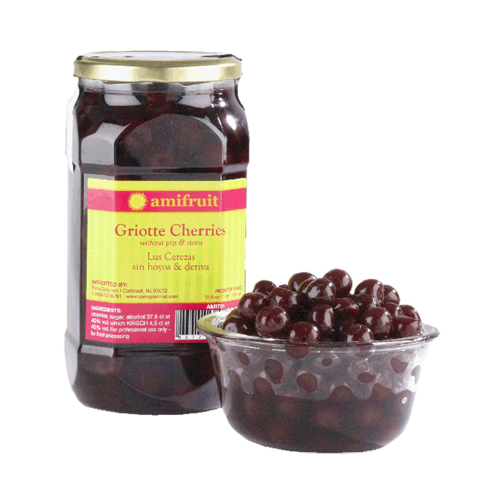 Jar of Amifruit griotte cherries in brandy next to a bowl of cherries