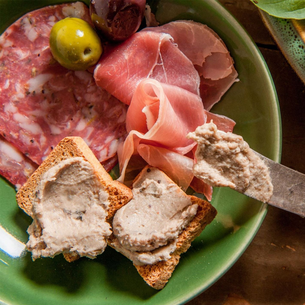 Petits toasts on a plate with charcuterie