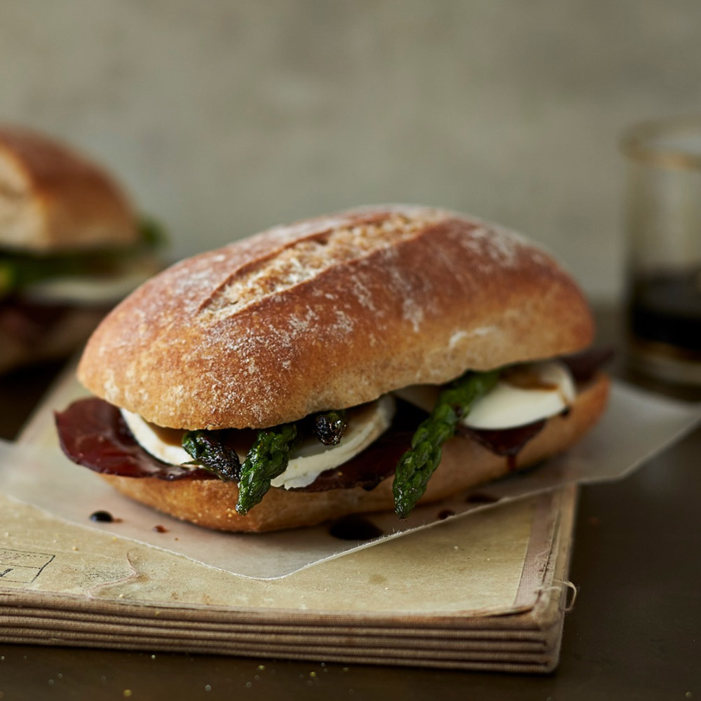 A sandwich with slices of bresaola and fresh mozzarella cheese