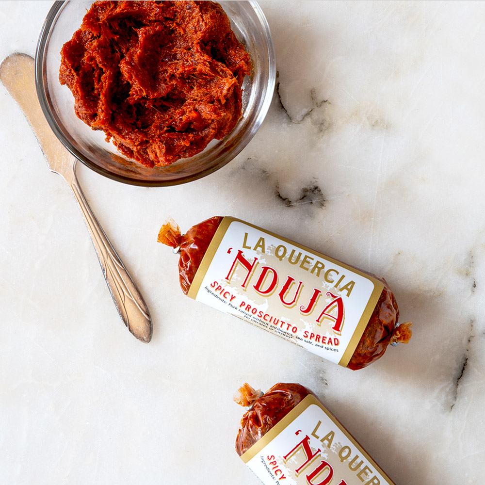 la quercia 'nduja spicy prosciutto spread in cup with la quercia 'nduja spicy prosciutto spread wrapped in packaging