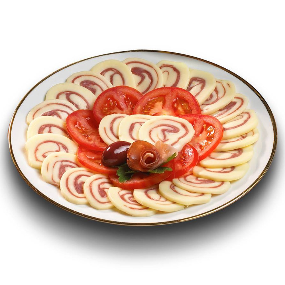 a plate of sliced roltini with slices of tomato