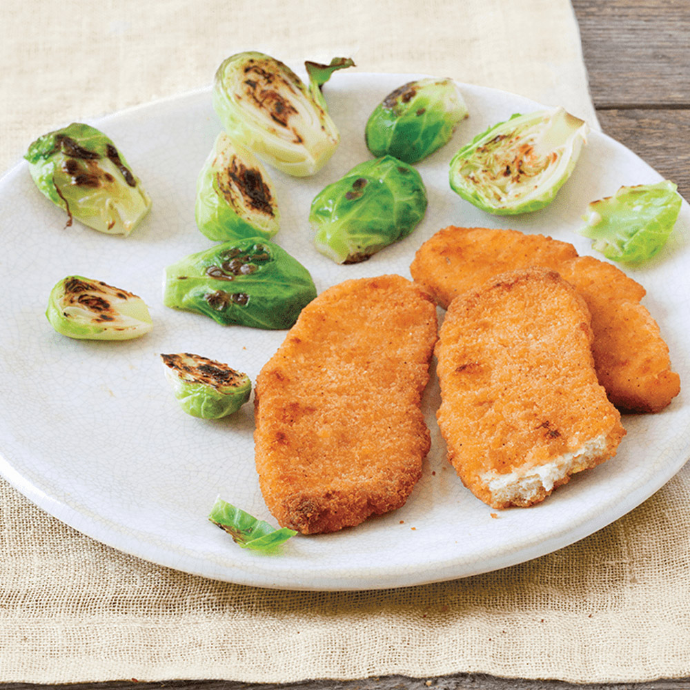 applegate organics organic chicken strips cooked on plate with brussel sprouts