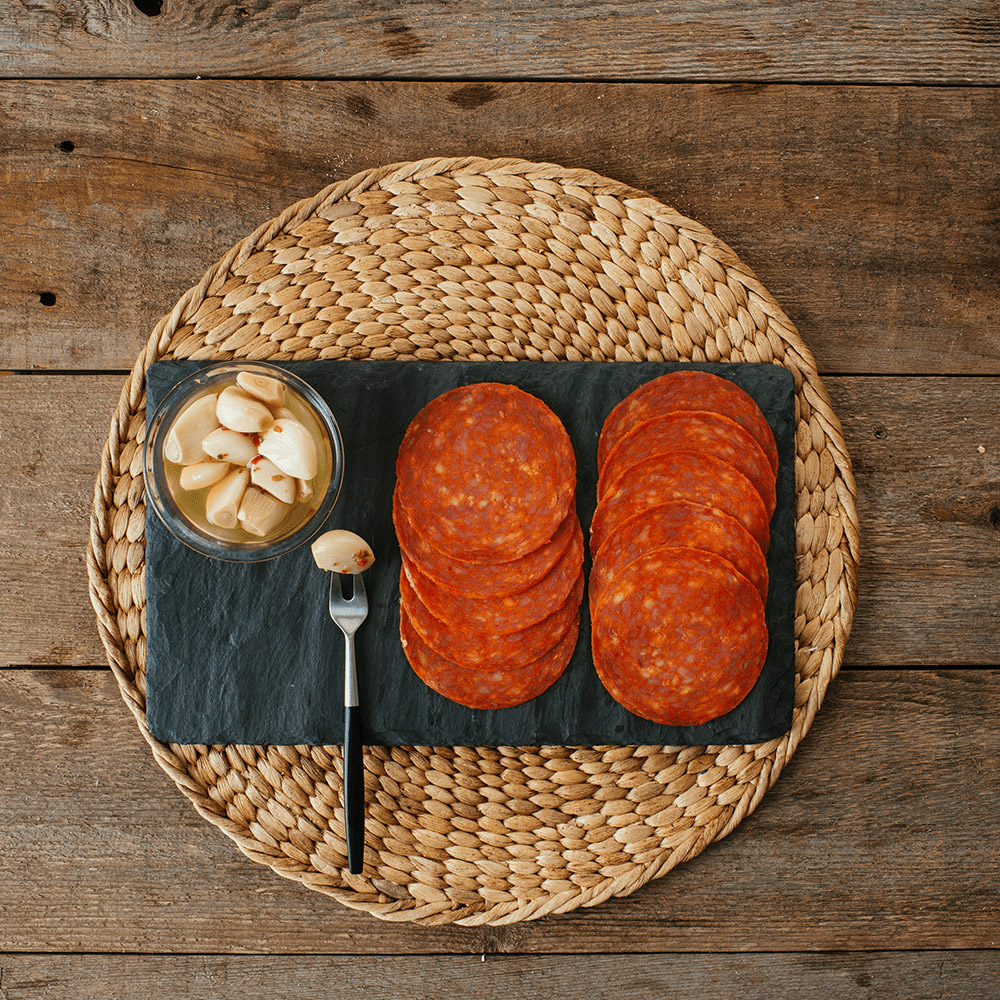 applegate naturals uncured pork & beef pepperoni with accompaniments on plate