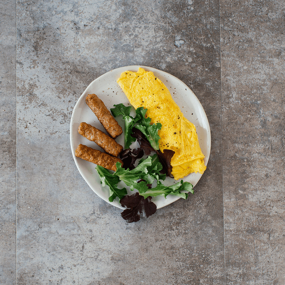 applegate naturals classic pork breakfast sausage links cooked on plate with eggs and vegetables