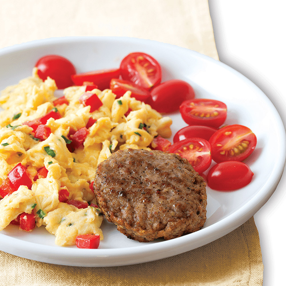applegate naturals savory turkey breakfast sausage patties cooked on plate with eggs and tomatoes