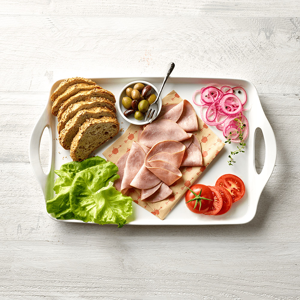 applegate naturals sliced uncured honey ham on plate with lettuce and bread and olives and onions and tomatoes
