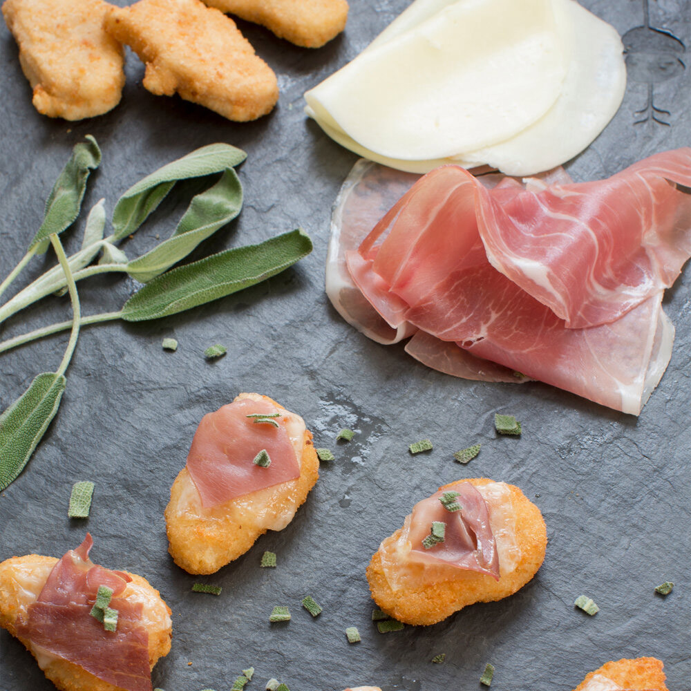 applegate naturals sliced prosciutto on serving tray with chicken nuggets and cheese