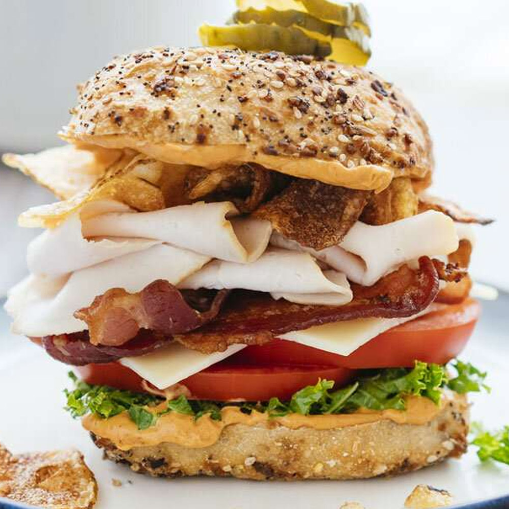 A turkey and bacon sandwich on a sandwich roll