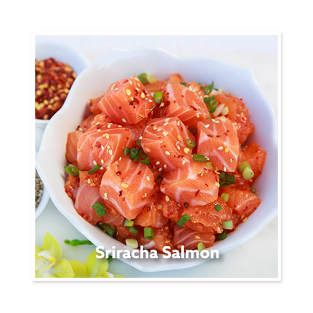 A bowl of raw salmon cubes topped with green onions