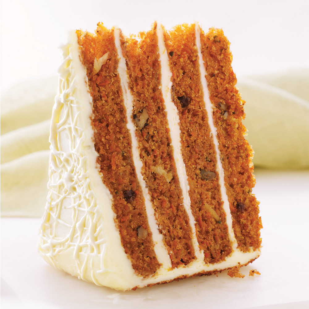Piece of Sweet Street four-layer carrot cake standing on its side