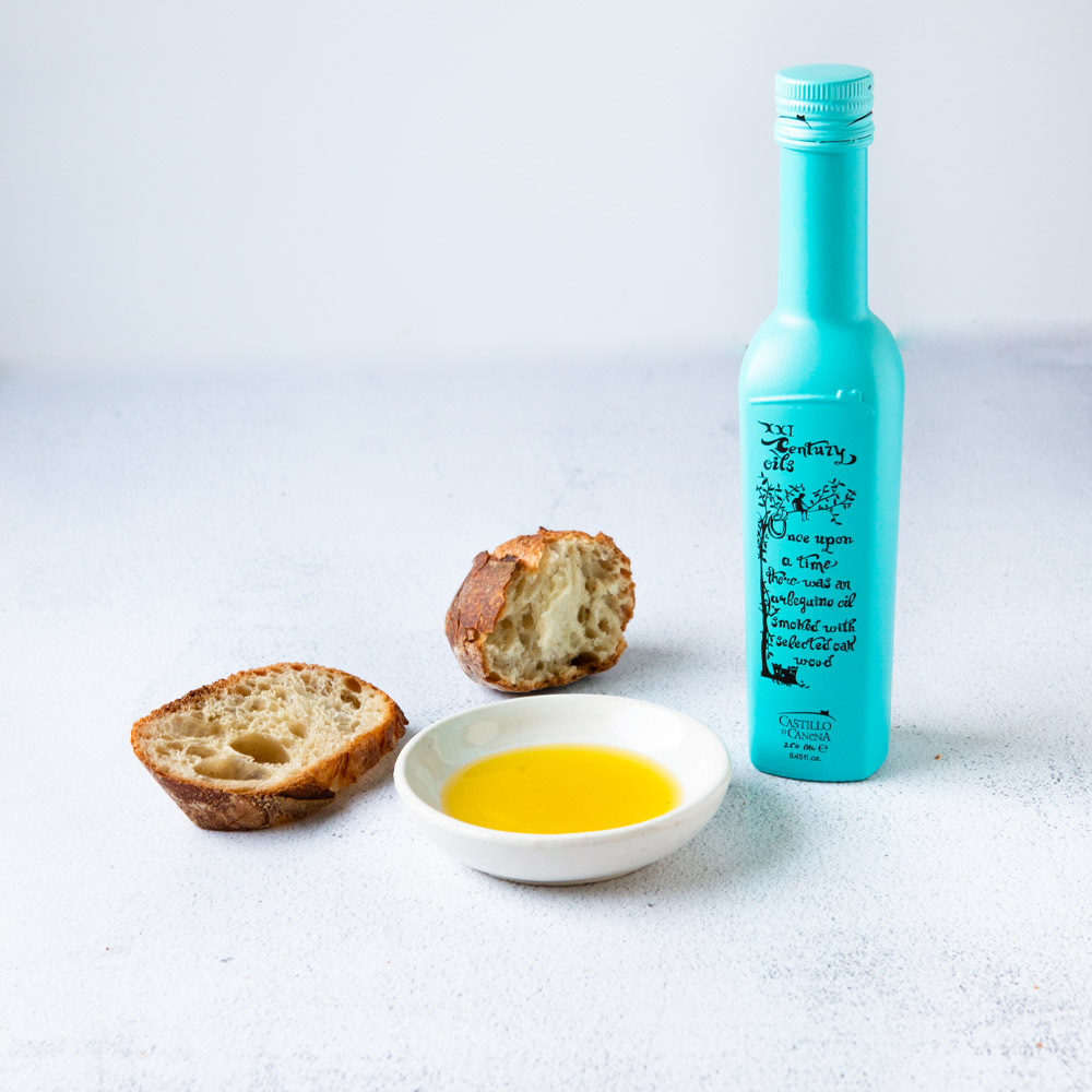 castillo de canena smoked arbequina olive oil with oil in cup and bread