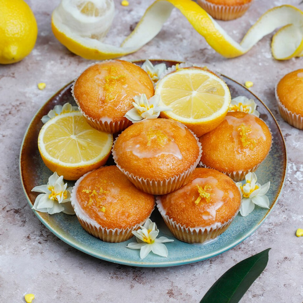 A plate of lemmon muffins topped with lemon zest
