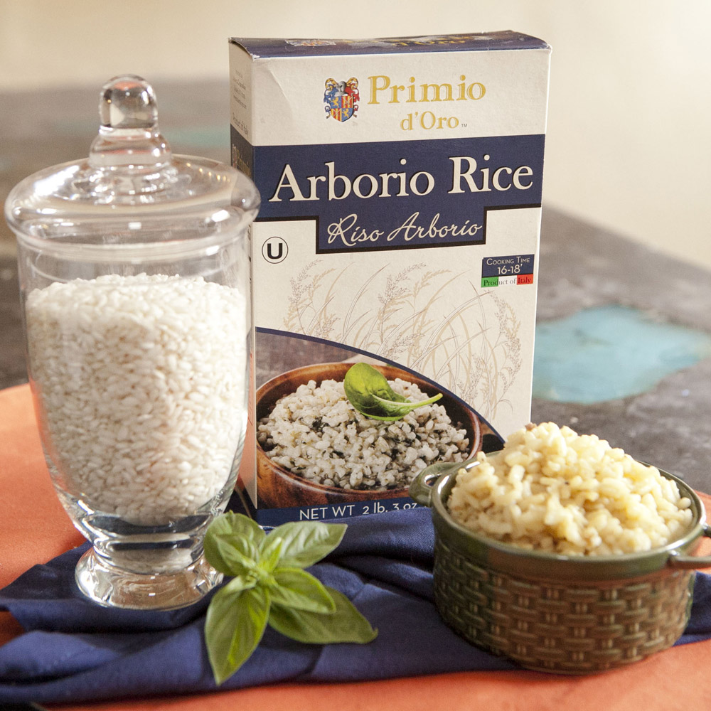 Box of Primo d'Oro arborio rice with a bowl and glass canister of rice on top of a table
