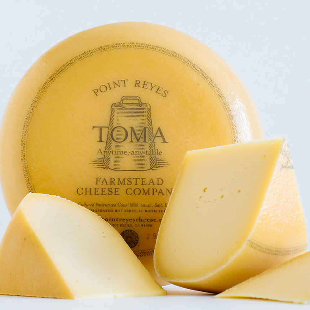 sliced wheel of point reyes toma wheel cheese