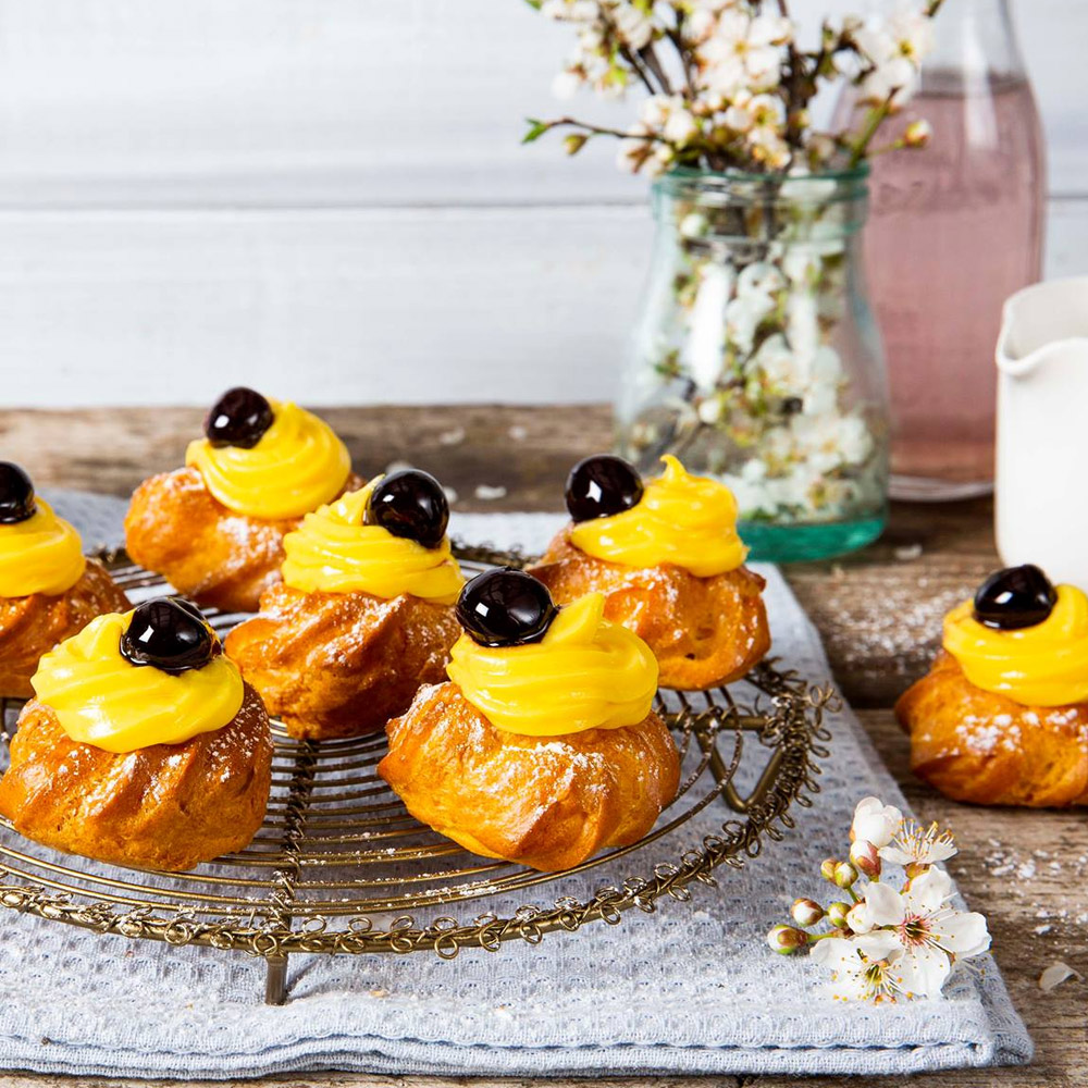 Pastries on a plate topped with amarena cherries