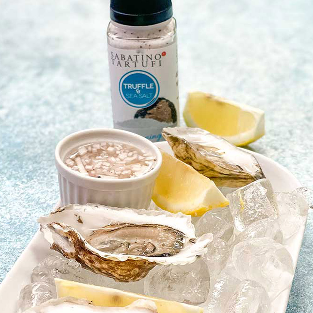 sabatino tartufi truffle & sea salt on cutting board with oysters and lemon wedges